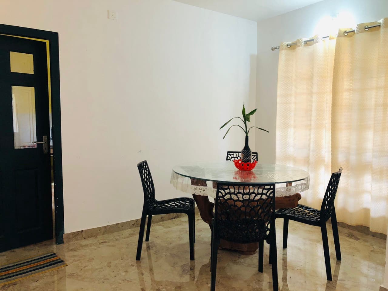 Bright dining table and chairs setup inside the villa