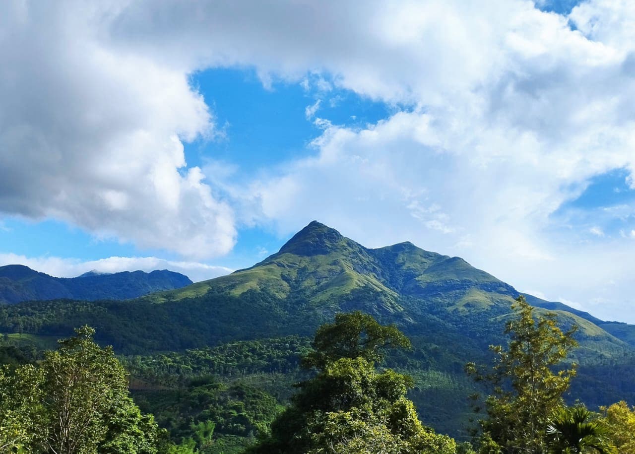 Majestic view of Chembra Peak and the green mountain valleys of Meppadi